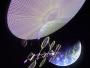 This giant disk floating in space isnít a UFO. Itís a power generator, harvesting energy from the Sun for a variety of uses back on Earth. Such space-based solar power generators have many applications, not just on Earth, but also in space. Two small solar panels could power a communications satellite, four panels might power a robotic interplanetary probe, six a manned spacecraft, while 20 panels might supply energy to a lunar base. SunTowerfot. NASA